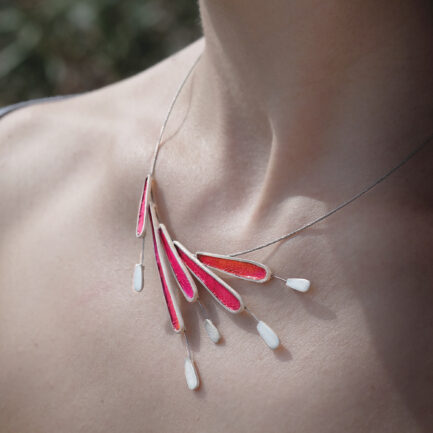 Silver feather-like statement necklace with coloured paper inlay