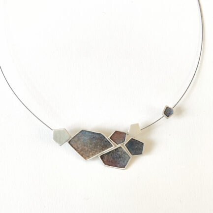 Silver rock-shaped statement necklace with coloured paper inlay